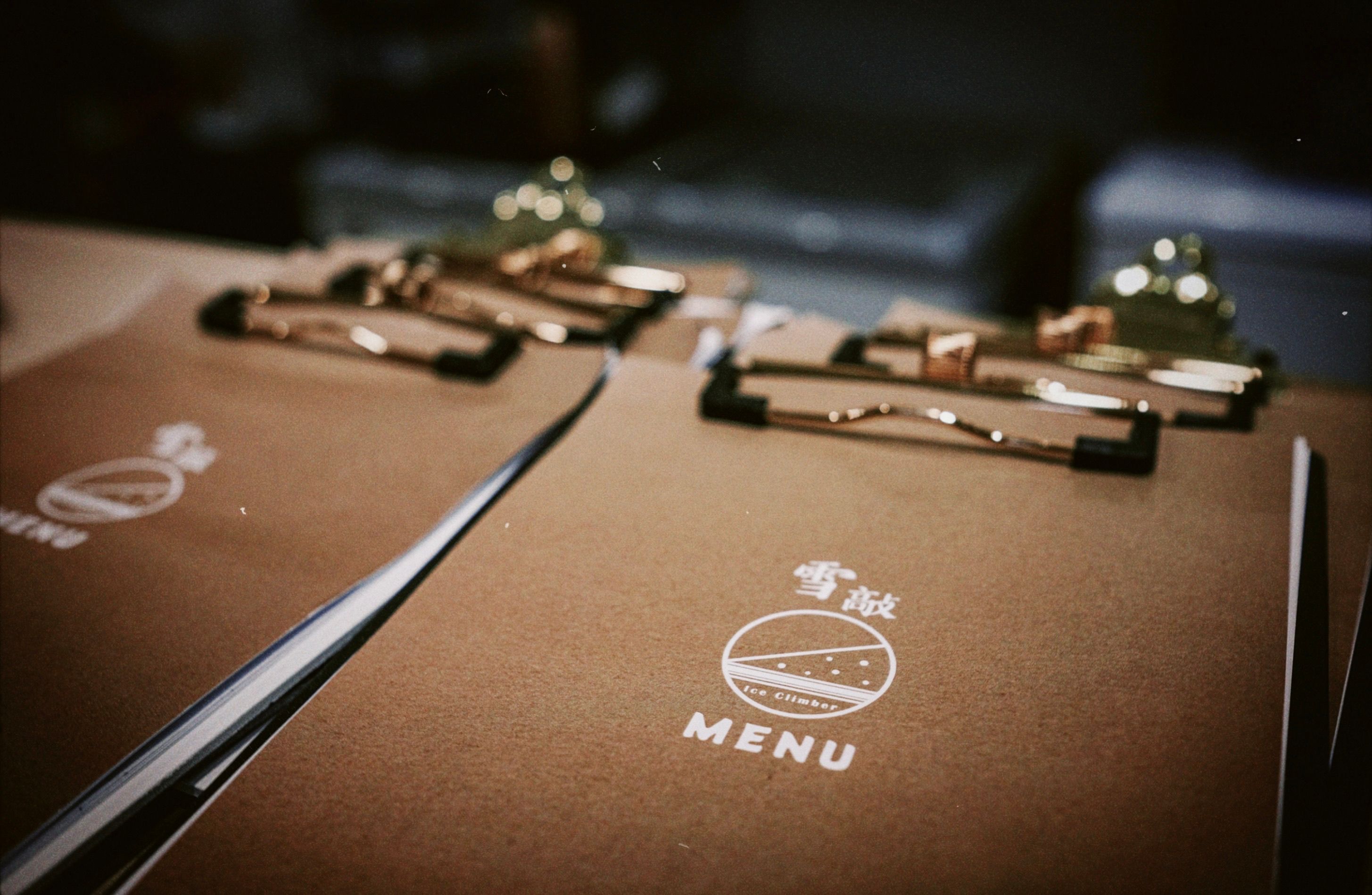 Stylish clipboards holding printed restaurant menus for diners